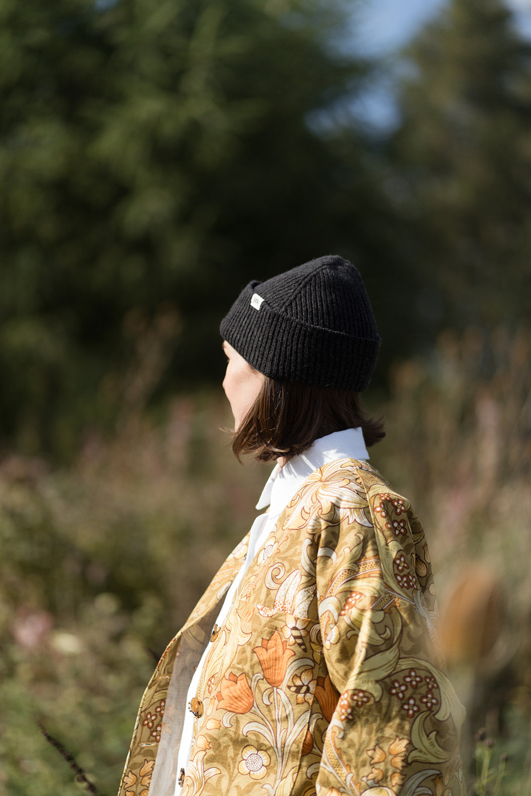 girl wearing LAW Design patterened jacket in the forest