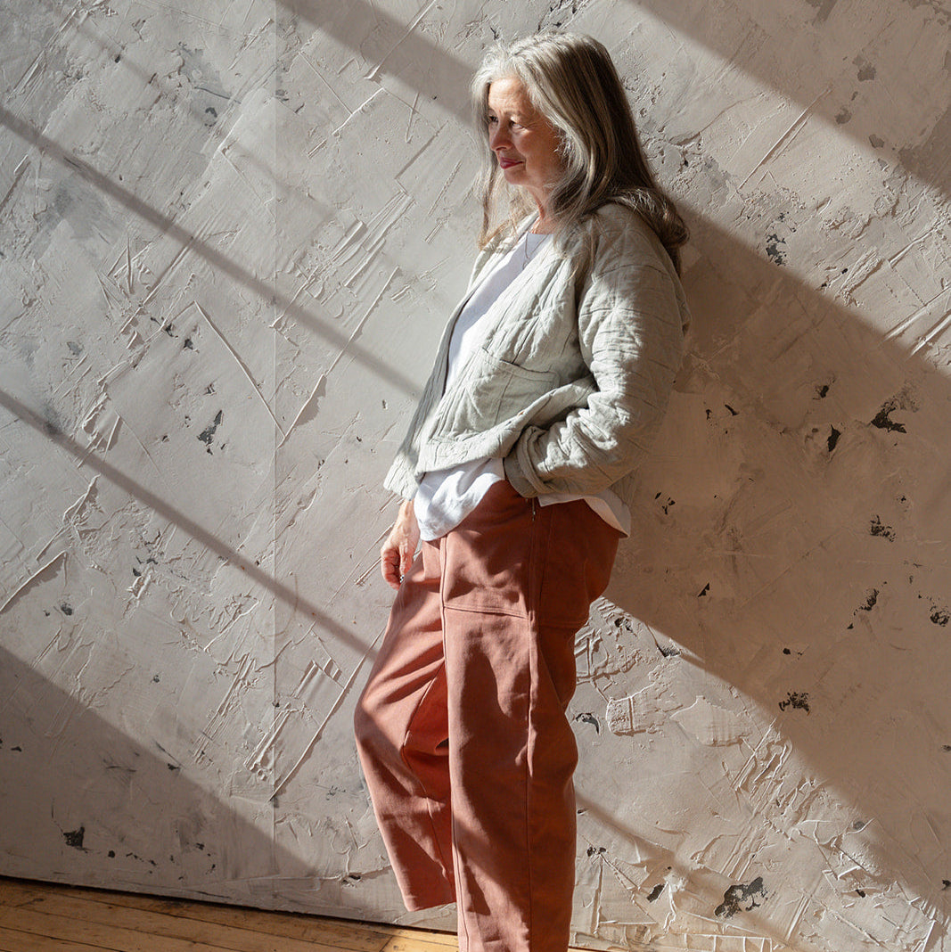 LAW Design studio Person standing in a room with sunlight casting shadows on the wall